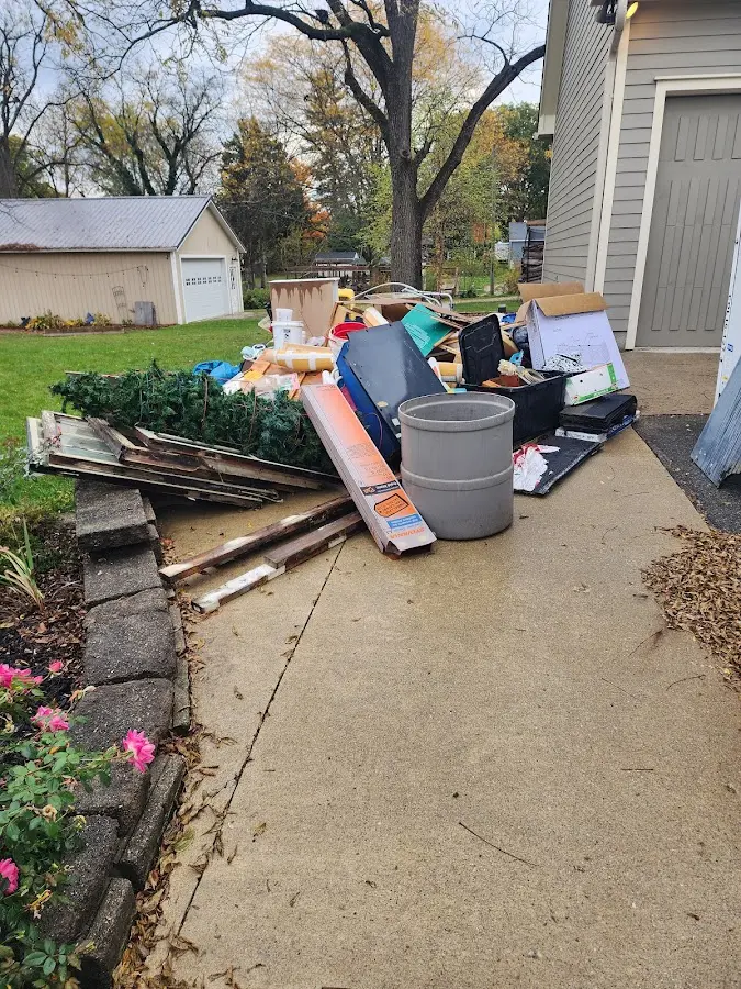 Dumpster being loaded with debris for 10 Yard Dumpster Rental in Grandwood Park